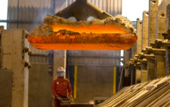 A worker removes an anode with a crane at Century's Grundartangi smelter.