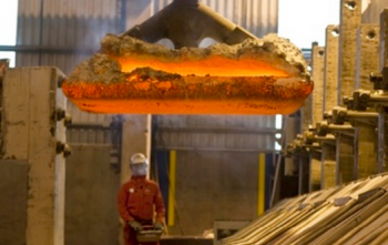 A worker removes an anode with a crane at Century\'s Grundartangi smelter.