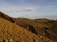 This mountain is being blown up with explosive to make way for boreholes.