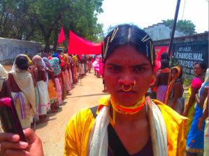 Dongria activist uses a phone to document the police at a six day foot-march to prepare for